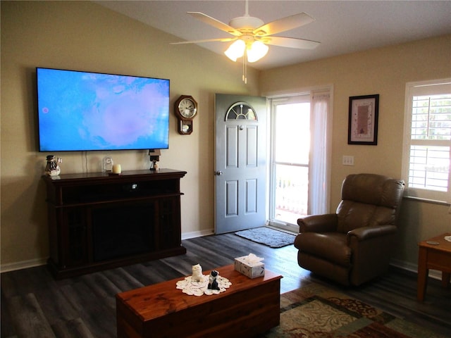 living room featuring dark hardwood / wood-style floors and ceiling fan