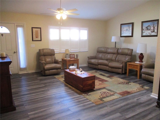 living room featuring dark hardwood / wood-style flooring, lofted ceiling, and ceiling fan