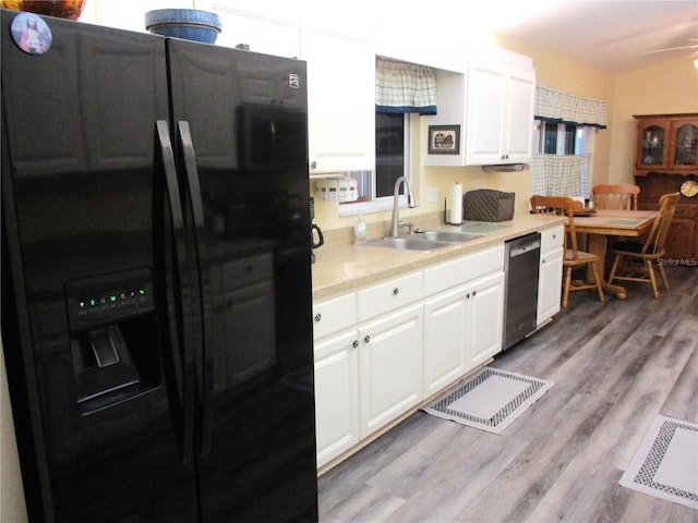 kitchen featuring black refrigerator with ice dispenser, sink, white cabinets, dishwasher, and light hardwood / wood-style flooring