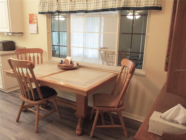 dining space featuring wood-type flooring