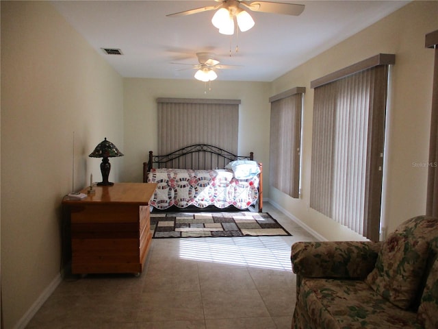 bedroom with ceiling fan and tile patterned floors