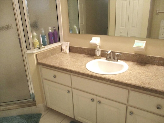 bathroom with vanity, tile patterned floors, and a shower with door