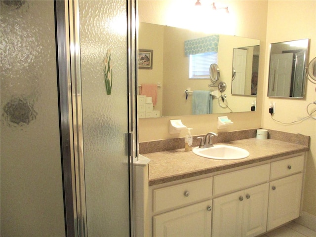 bathroom with vanity and a shower with shower door