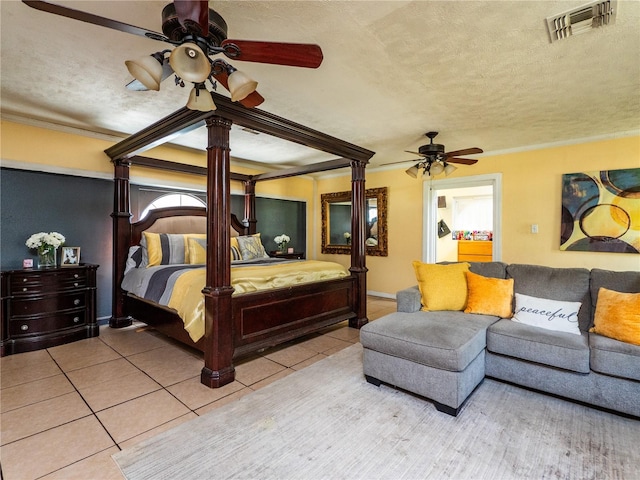 tiled bedroom featuring ceiling fan, crown molding, and a textured ceiling