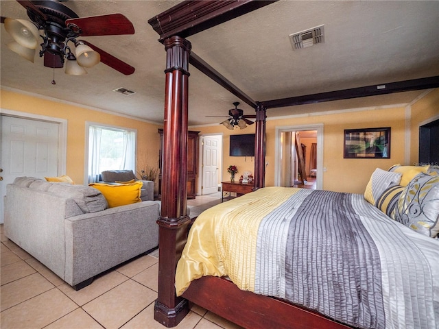 bedroom with ceiling fan, a textured ceiling, decorative columns, and light tile patterned flooring