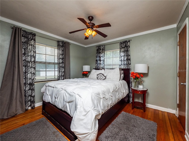 bedroom featuring ceiling fan, crown molding, and dark hardwood / wood-style flooring