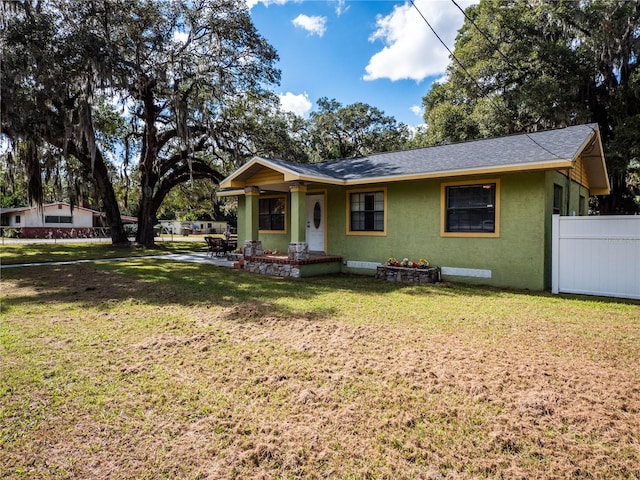 ranch-style home featuring a front yard