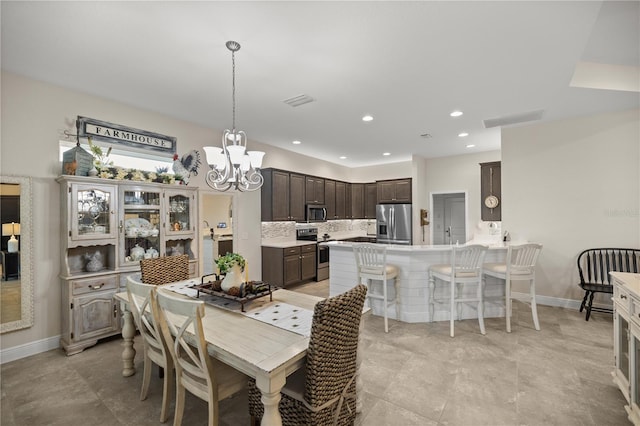 dining area with an inviting chandelier