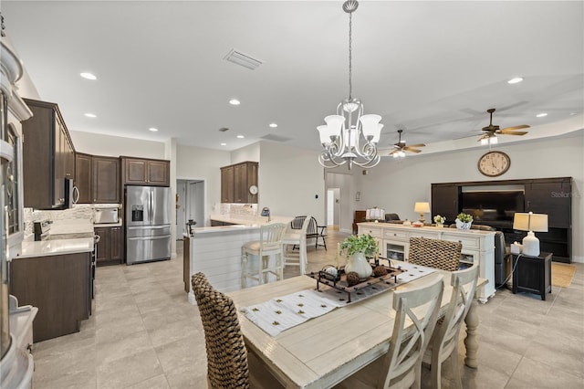 tiled dining area with an inviting chandelier