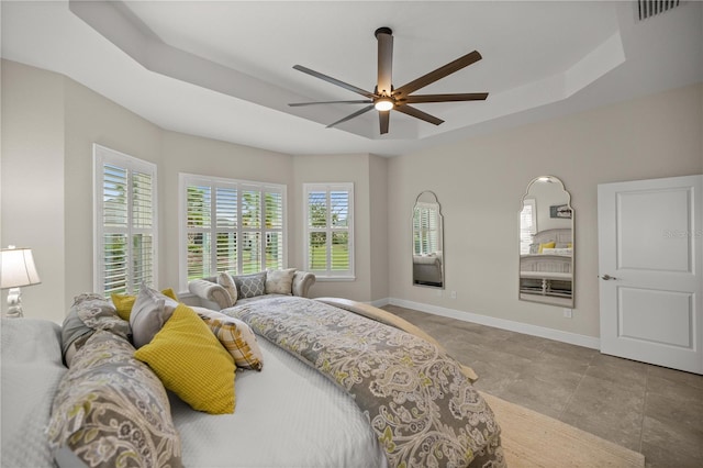 bedroom featuring ceiling fan and a raised ceiling