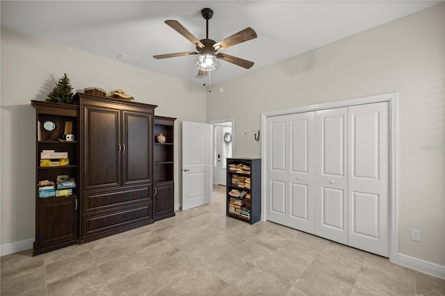 bedroom with ceiling fan and a closet