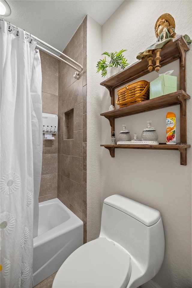 bathroom featuring shower / bath combo and toilet