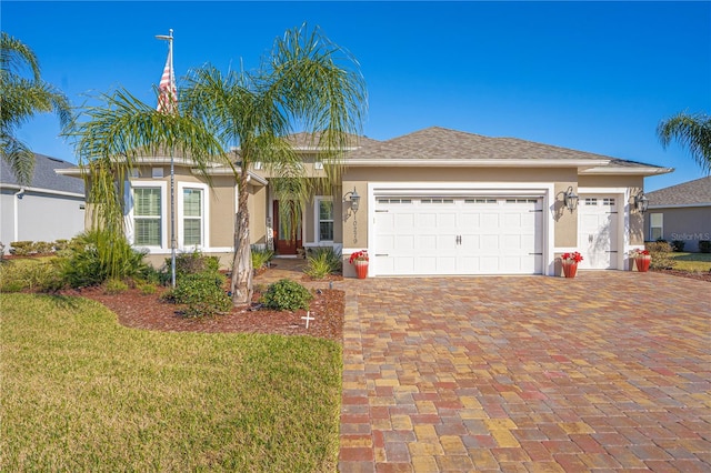 ranch-style home with a garage and a front yard