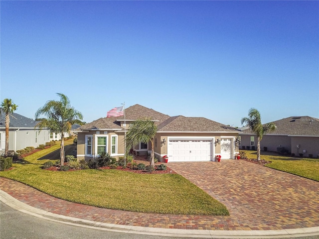 single story home featuring a front lawn and a garage