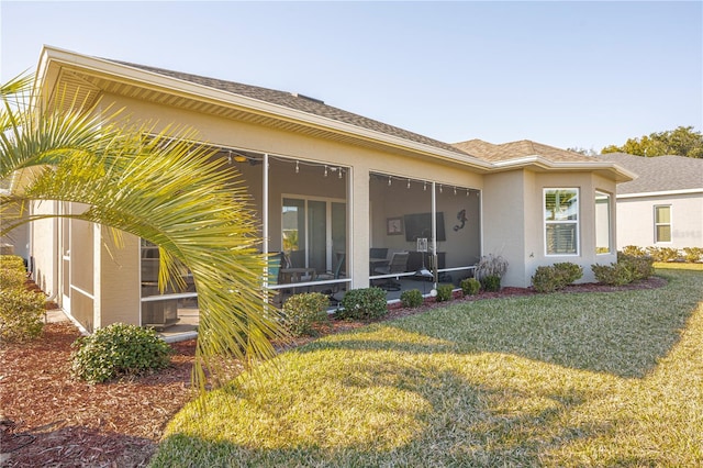 exterior space featuring a lawn and a sunroom