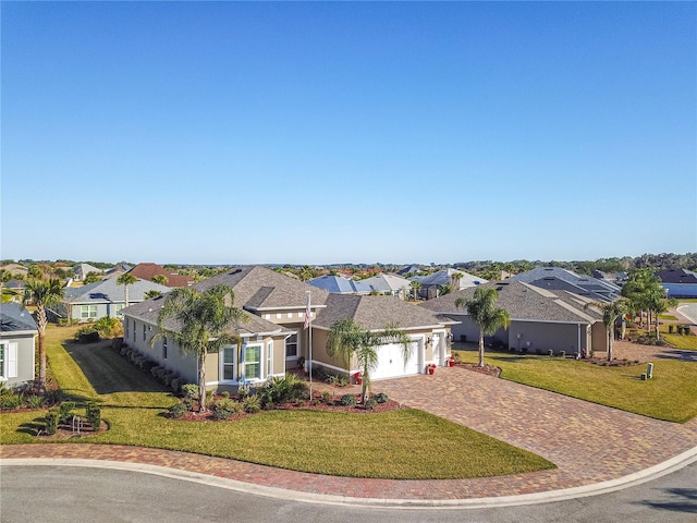 view of front of home with a front lawn and a garage