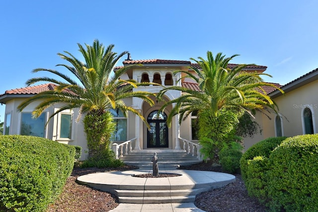 mediterranean / spanish-style house featuring french doors