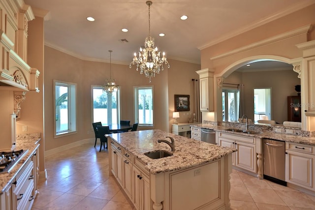 kitchen with a center island with sink, sink, and light stone counters