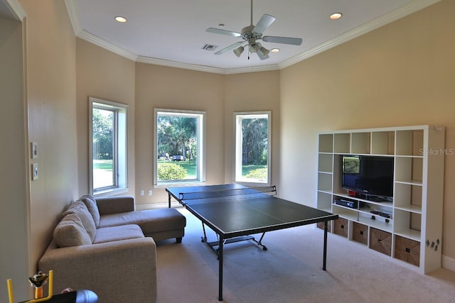 game room featuring light carpet, ceiling fan, and crown molding