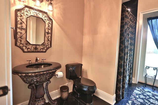 bathroom with tile patterned flooring and toilet