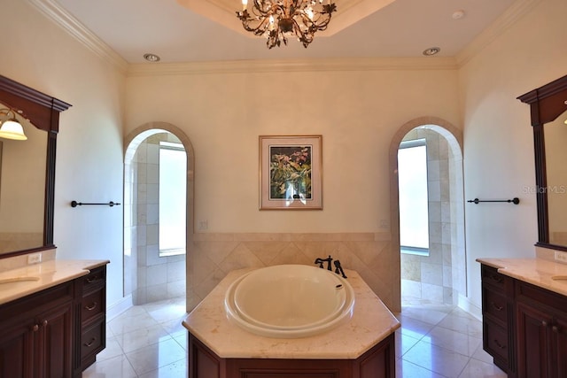 bathroom featuring tile walls, ornamental molding, vanity, tile patterned flooring, and a bathing tub