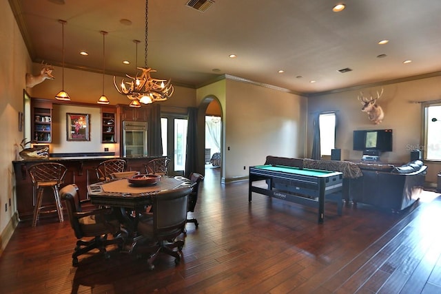 game room featuring dark hardwood / wood-style flooring, a chandelier, and crown molding