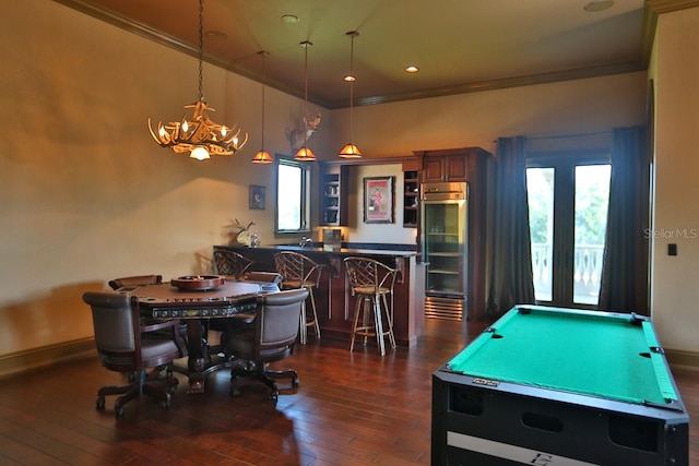 playroom with ornamental molding, pool table, a healthy amount of sunlight, and dark hardwood / wood-style floors