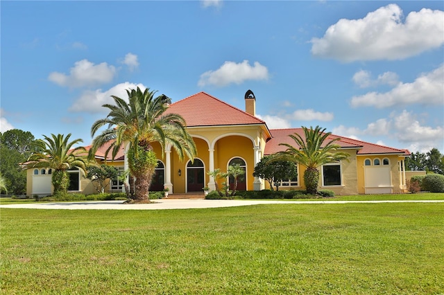 mediterranean / spanish house with a front yard