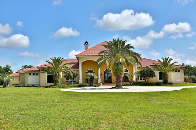 mediterranean / spanish-style home with a front lawn