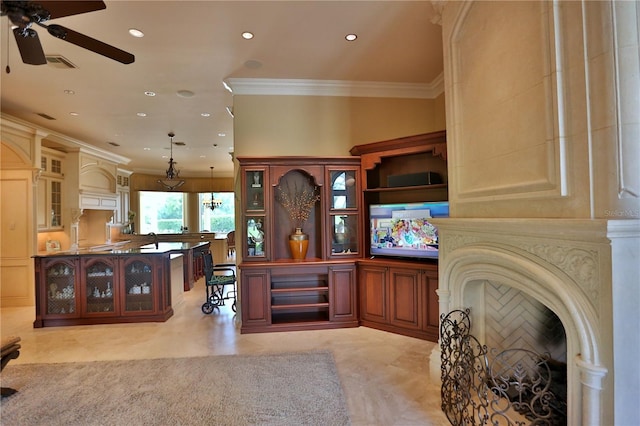 interior space featuring hanging light fixtures, ceiling fan, and ornamental molding