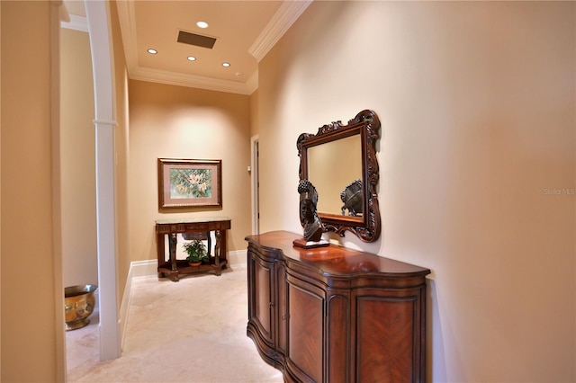 hallway with a high ceiling and ornamental molding