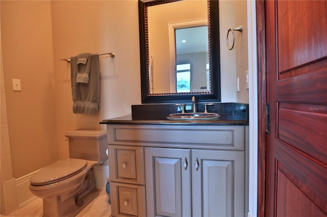 bathroom featuring toilet, vanity, and tile patterned floors