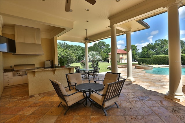 view of patio with an outdoor kitchen, ceiling fan, and a grill