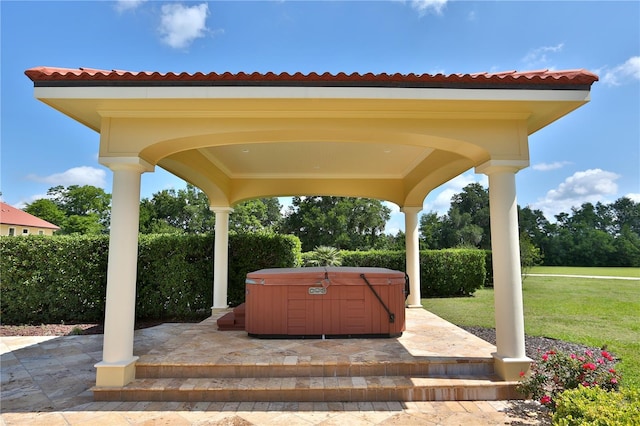 view of patio / terrace featuring a hot tub and a gazebo