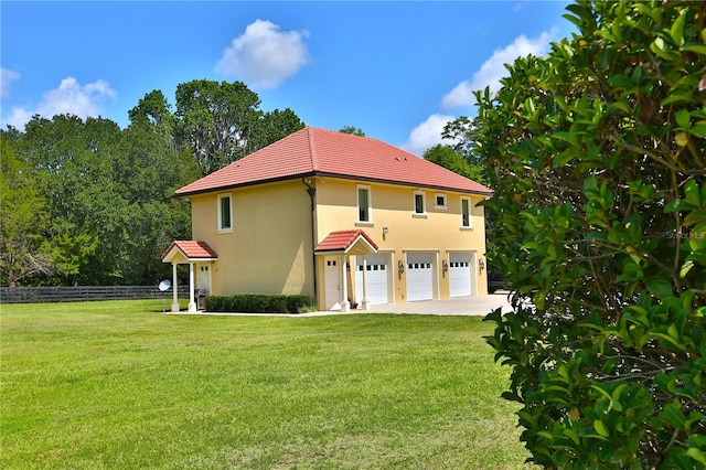 view of front of property featuring a garage and a front lawn