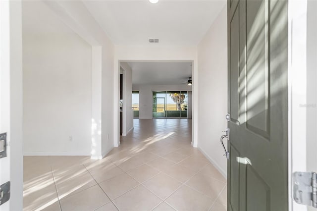 foyer featuring ceiling fan and light tile patterned floors