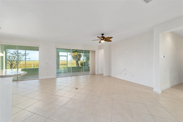 spare room featuring ceiling fan and light tile patterned flooring