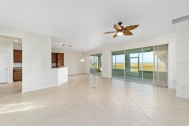 spare room featuring ceiling fan, light tile patterned flooring, and sink