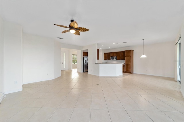 unfurnished living room with ceiling fan and light tile patterned floors