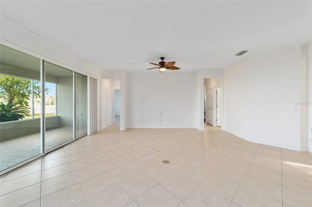 unfurnished room with light tile patterned floors and ceiling fan