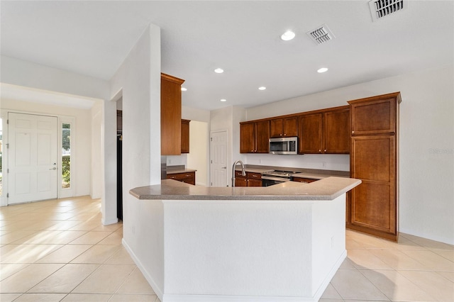 kitchen featuring sink, light tile patterned floors, and stainless steel appliances