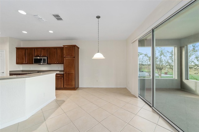 kitchen featuring light tile patterned floors and pendant lighting