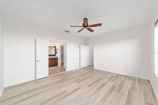 unfurnished bedroom with connected bathroom, ceiling fan, and light wood-type flooring