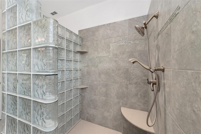 bathroom with a tile shower