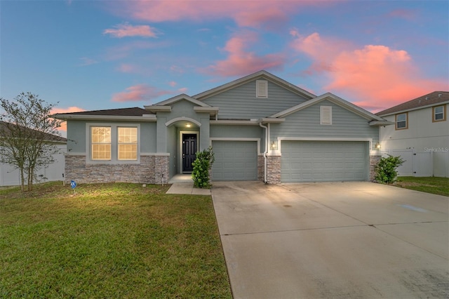 view of front of house featuring a garage and a yard