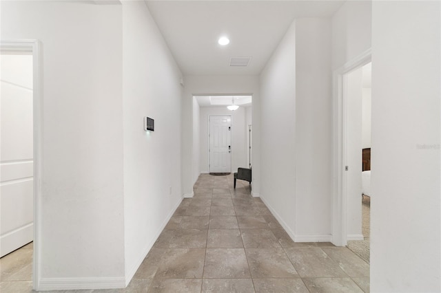 corridor with light tile patterned floors