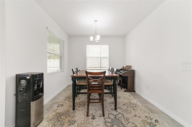 dining area with an inviting chandelier