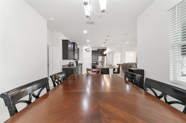 dining space featuring a healthy amount of sunlight and an inviting chandelier