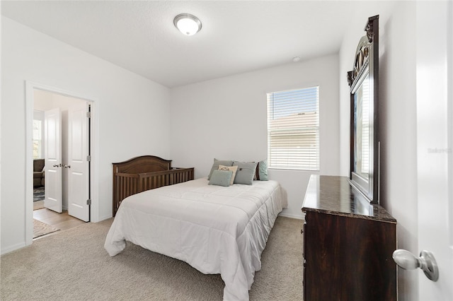 bedroom featuring light carpet