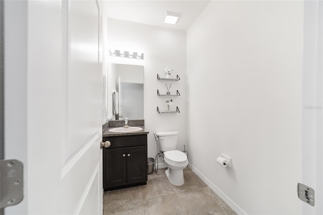 bathroom featuring toilet and vanity